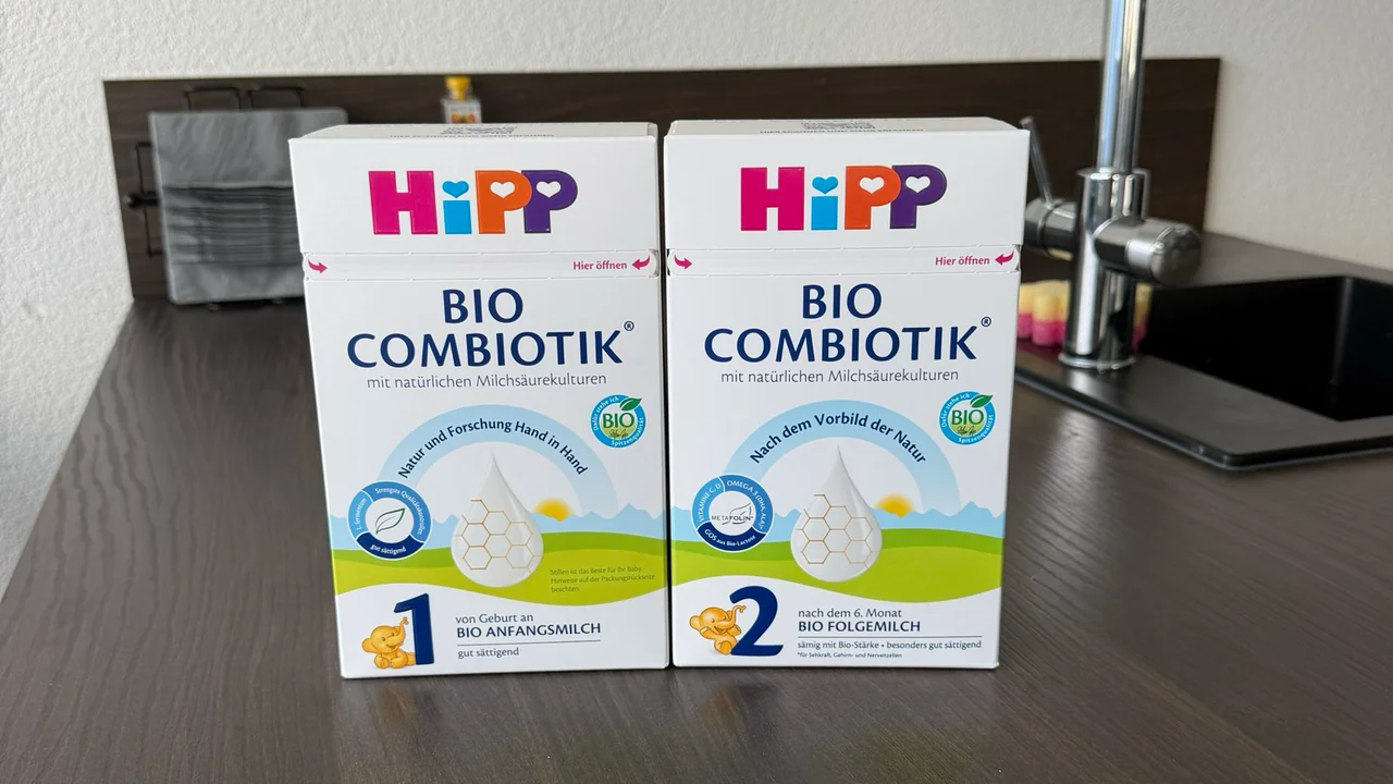 The German HiPP Bio Combiotik Stage 1 and Stage 2 boxes side by side on a kitchen counter, fronts to the camera.
